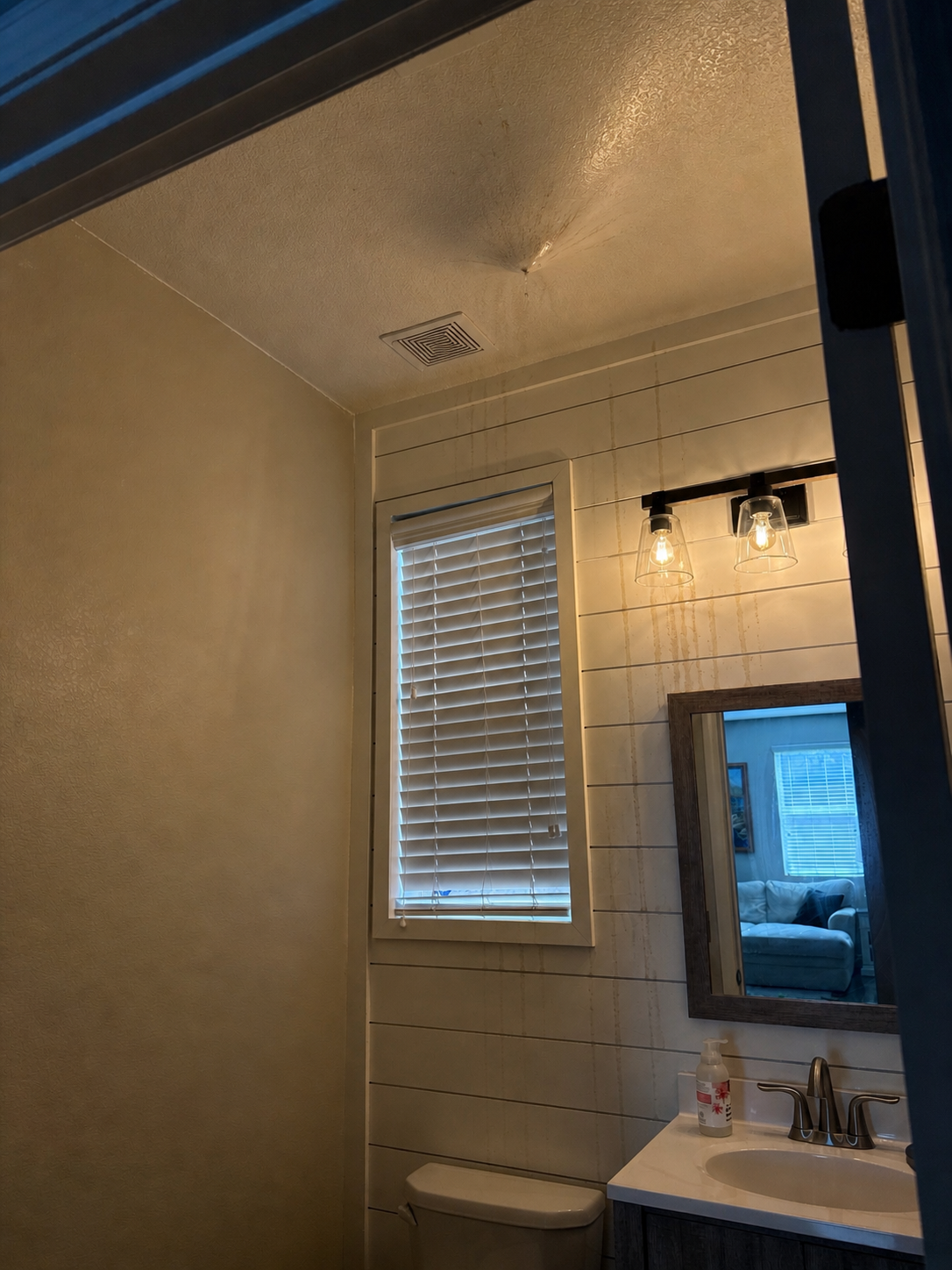Water damaged ceiling and wall from an upstairs pipe break
