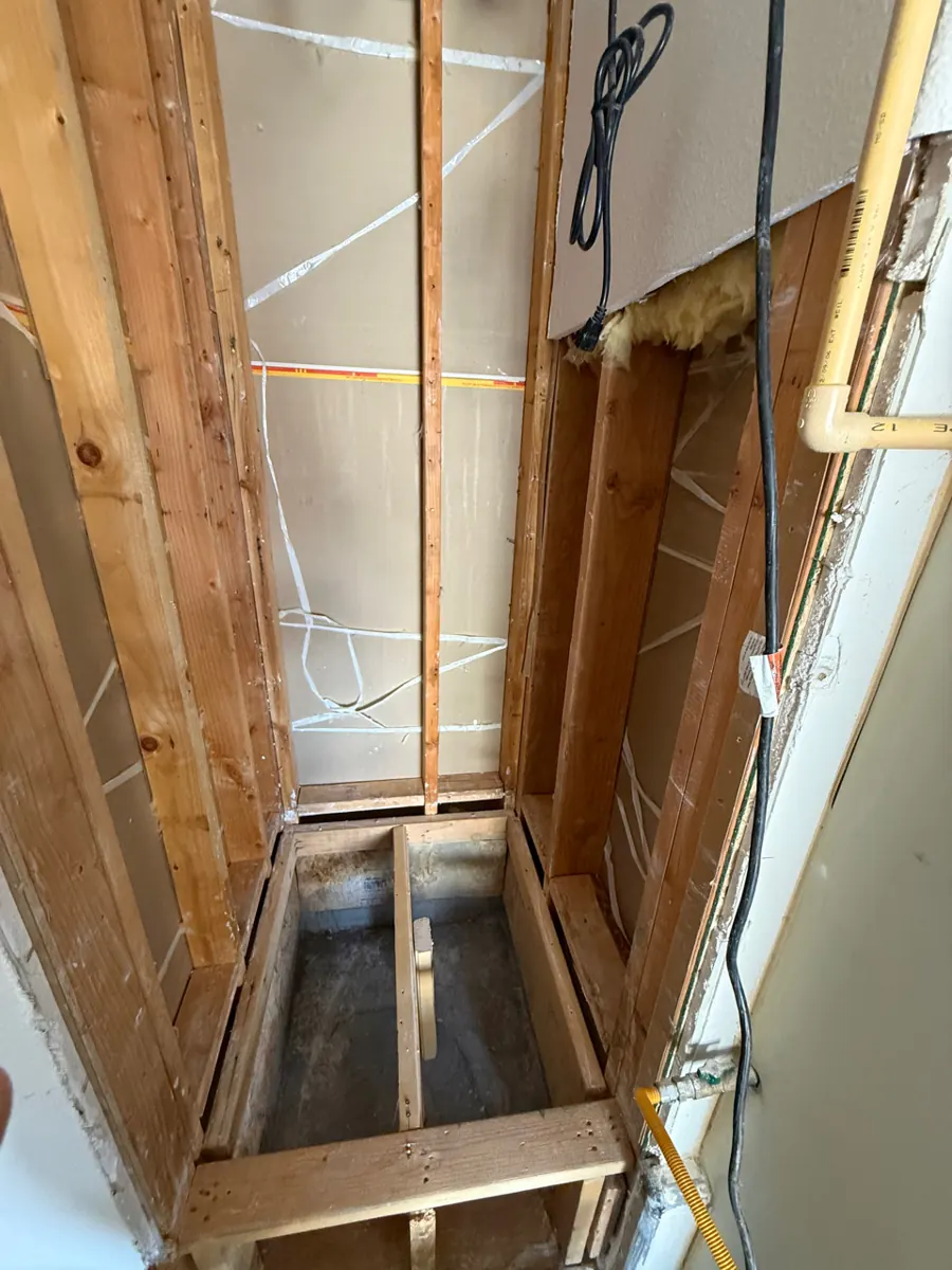 Water heater alcove opened to bare framing in an Aliante garage