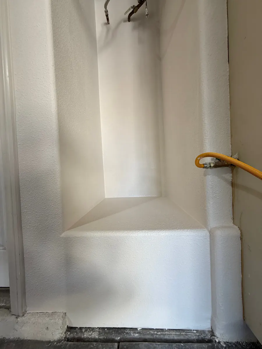 Water heater alcove rebuilt with new textured and primed drywall in an Aliante garage