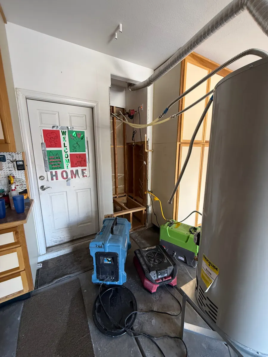 Dehumidifier and air movers beside the opened alcove in an Aliante garage