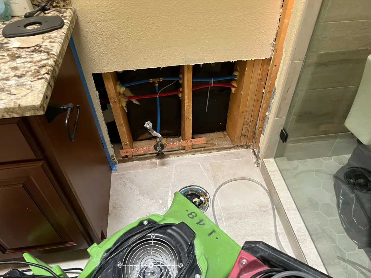 Bathroom wall opened beside the vanity with drying equipment in an Anthem home