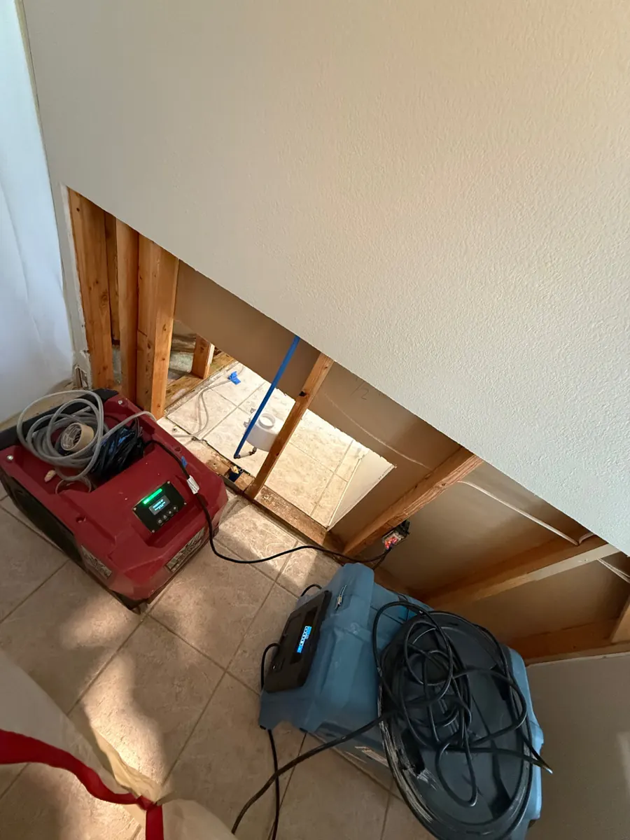Dehumidifier and air scrubber drying an opened wall in an Anthem home