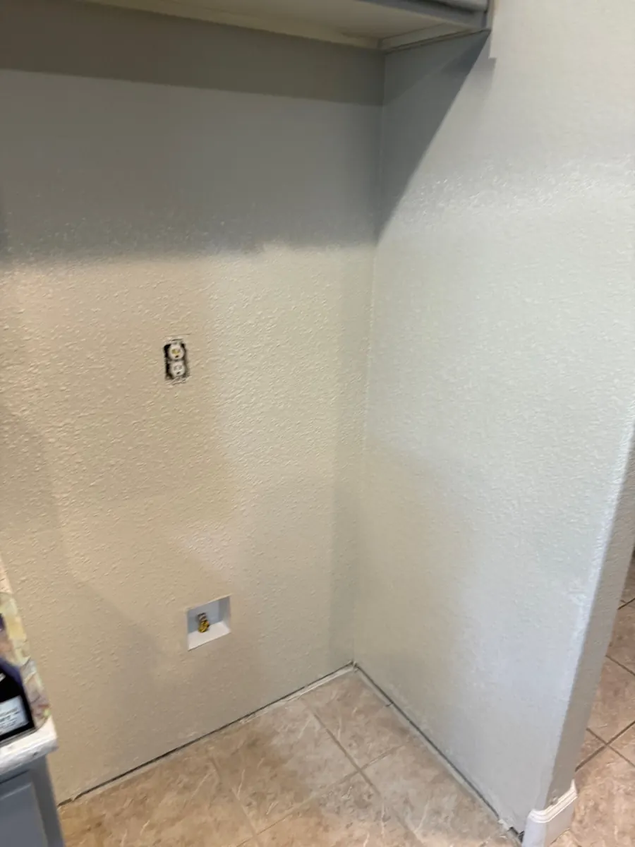 After: laundry wall with new drywall, texture and paint in an Anthem home