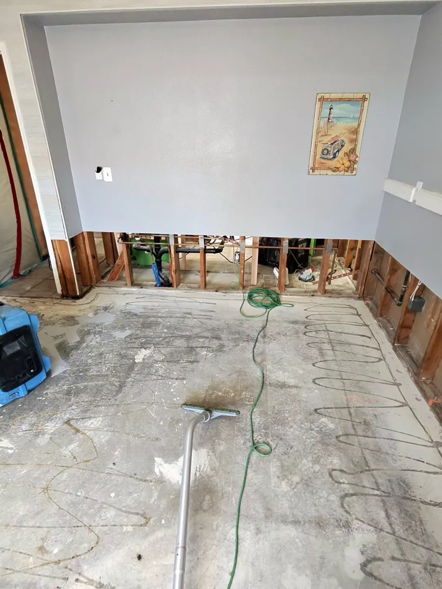Bedroom with lower walls cut open and flooring removed to the slab in a Centennial Hills home
