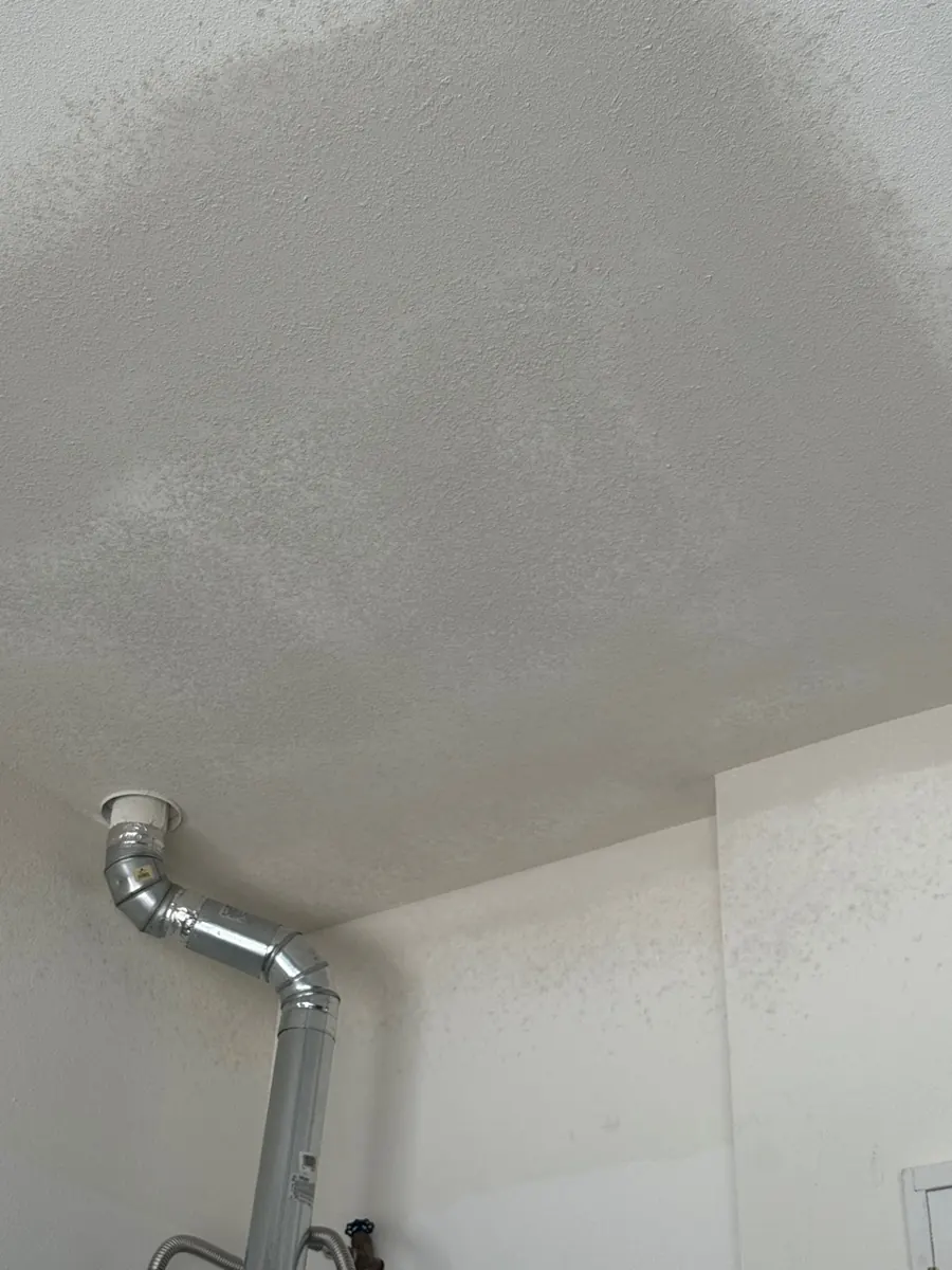After: garage ceiling repaired and textured around the water heater flue in a Centennial Hills home