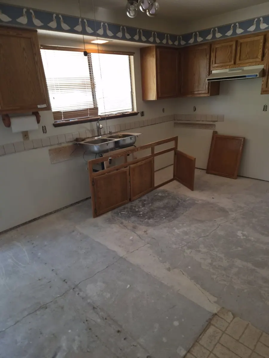 Kitchen with countertop and base cabinets removed over a bare slab in a Centennial Hills home