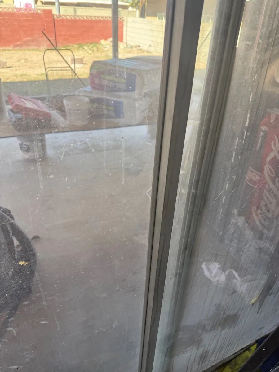Old, dirty sliding glass door before replacement in an East Las Vegas home