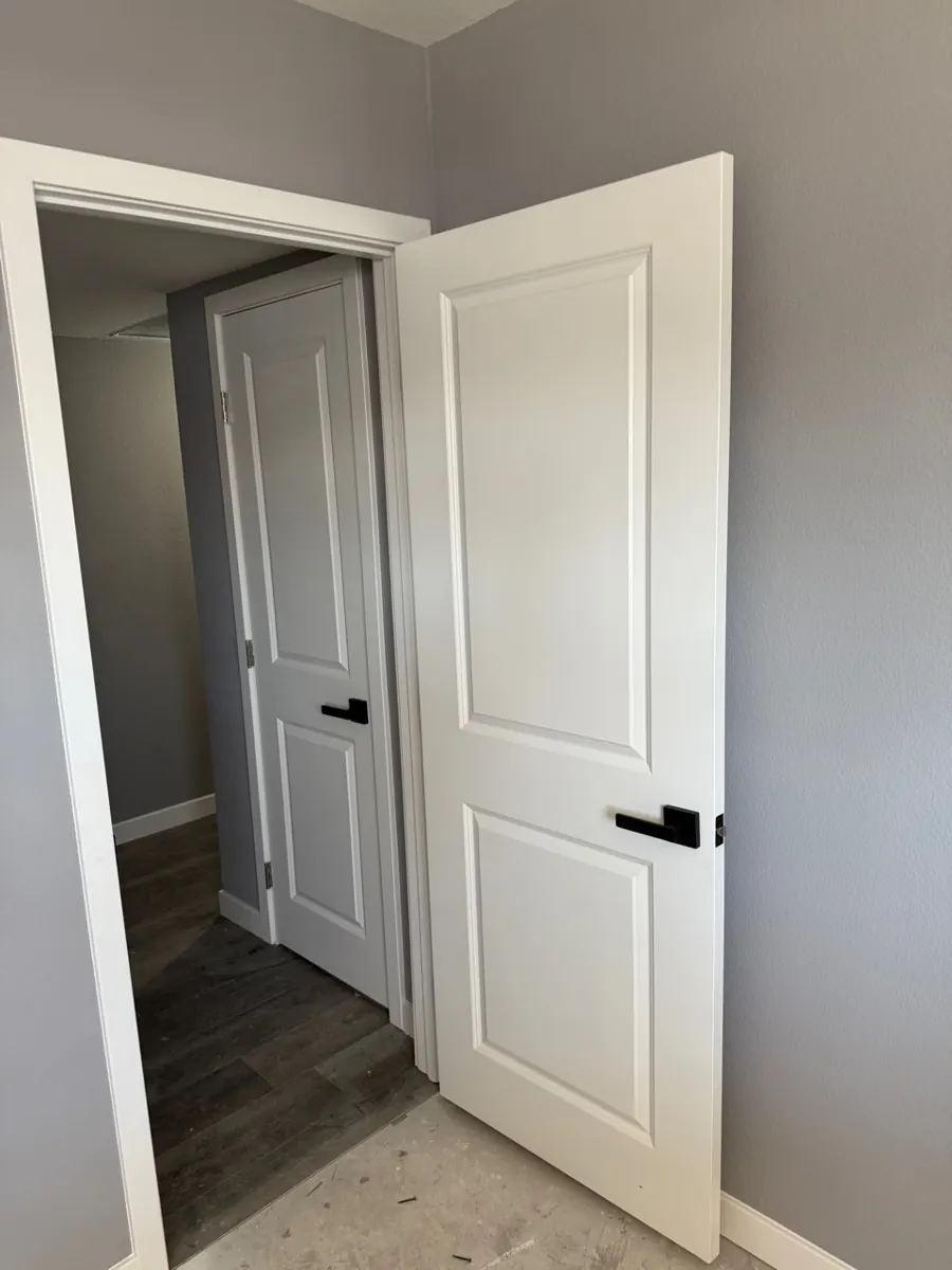 New white interior doors and wood-look flooring in an East Las Vegas hallway