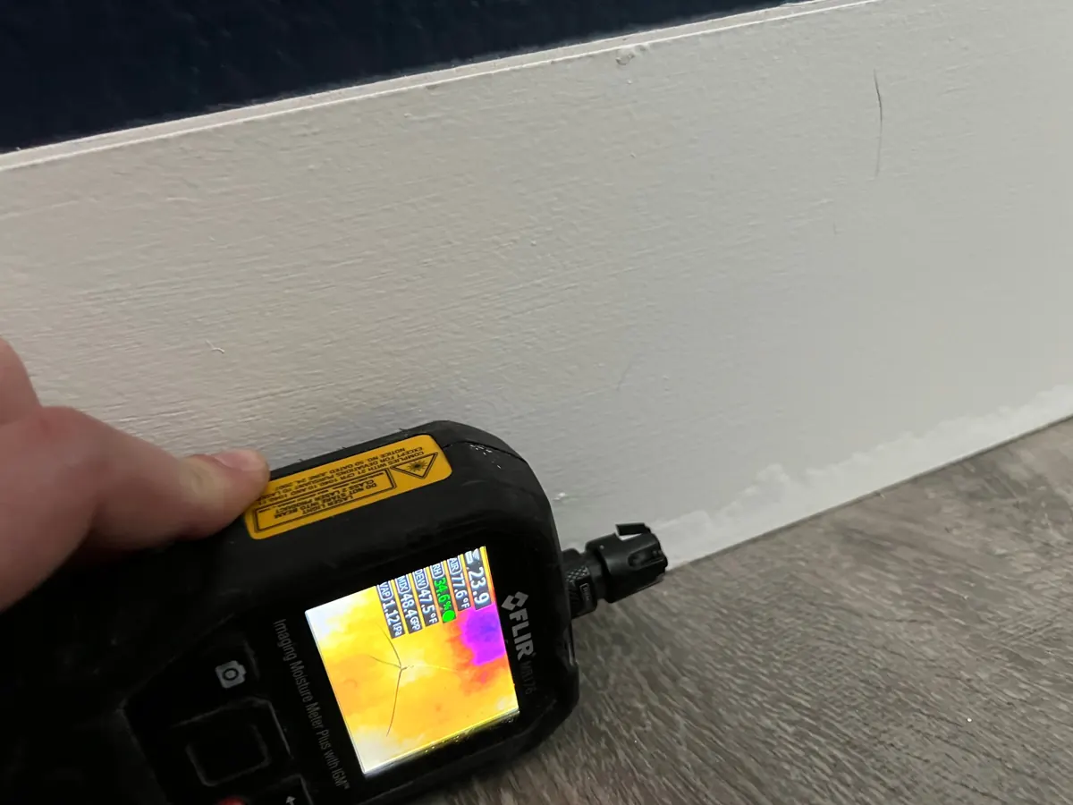 Thermal moisture meter at a bedroom baseboard in a Green Valley North home