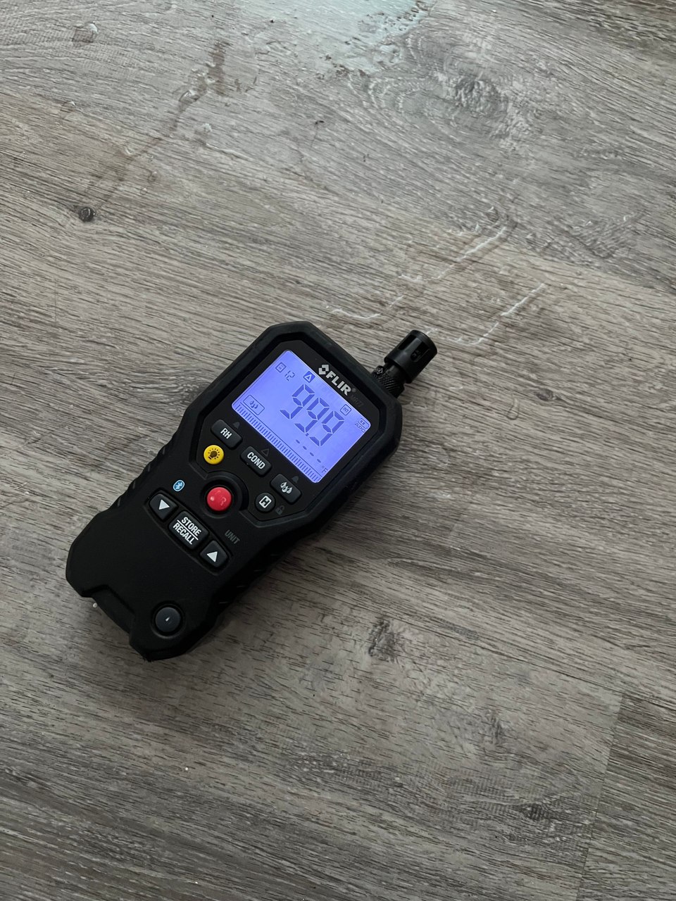 Moisture meter on flooring in the same Green Valley North home