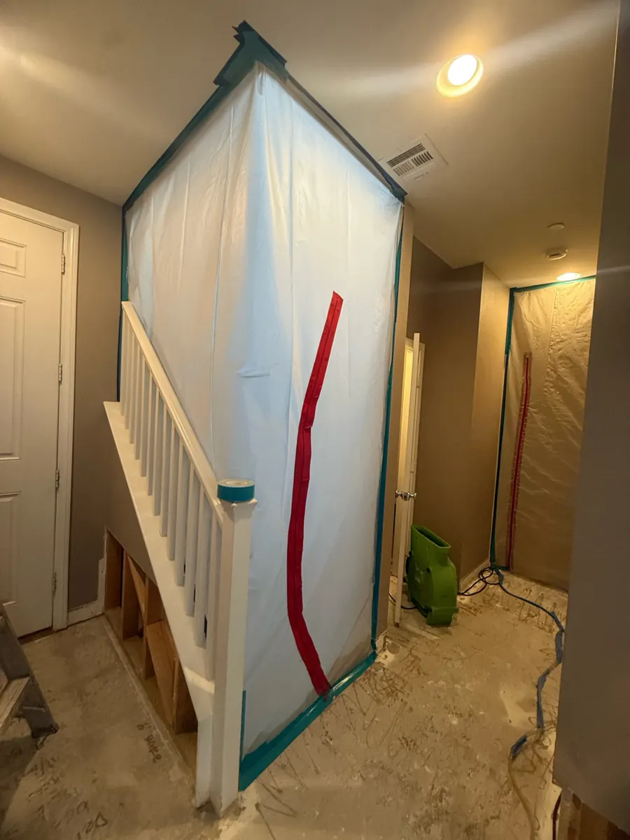 Plastic containment with zipper door beside the stairs in an Inspirada home