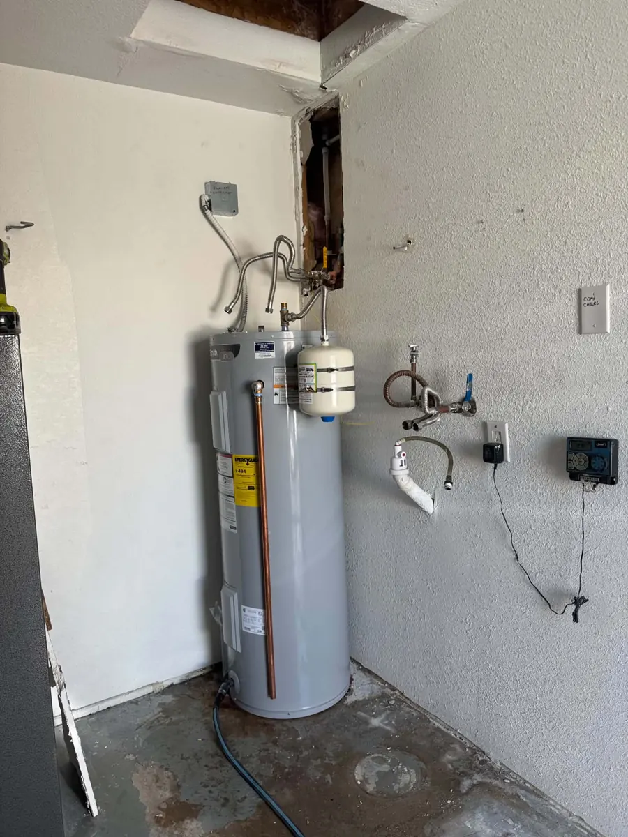 New garage drywall around the water heater after drying in a Lake Havasu City home