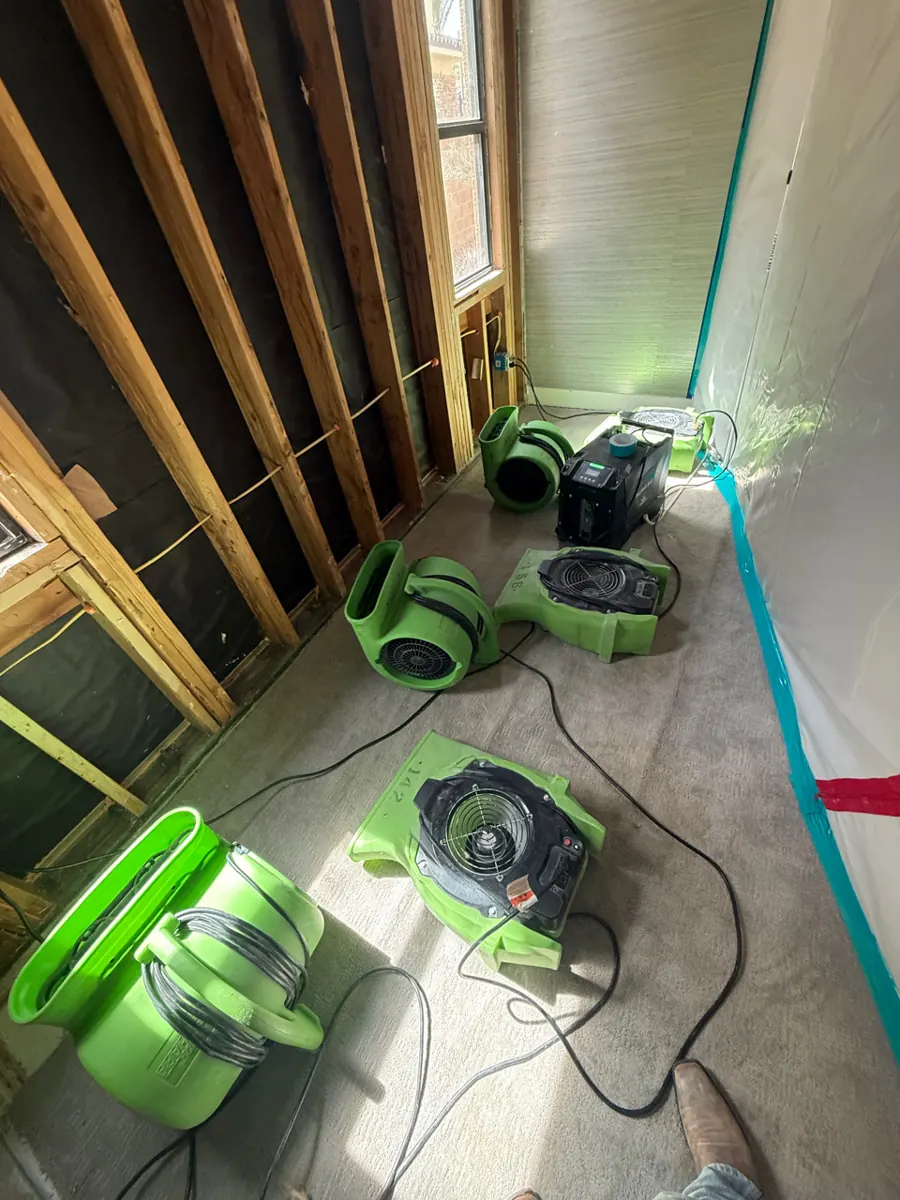 Air movers and dehumidifier drying opened walls in a Lake Las Vegas home