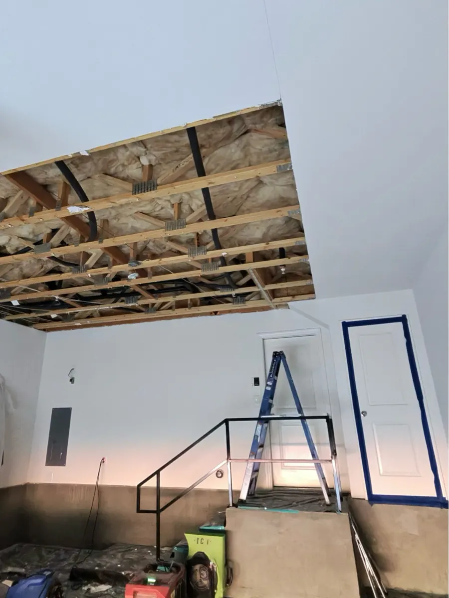 Garage ceiling drywall removed to expose joists and insulation in McCullough Hills