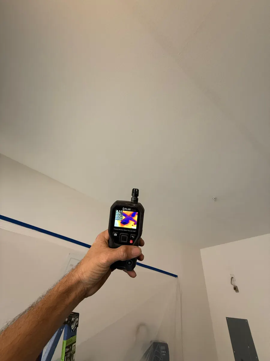 Thermal moisture meter aimed at a garage ceiling in a McCullough Hills townhome
