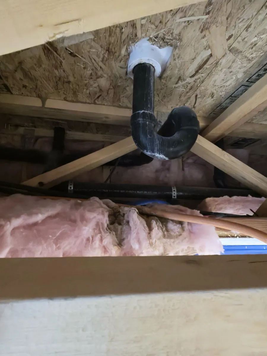 Drain pipe and insulation exposed inside an opened kitchen ceiling in North Las Vegas
