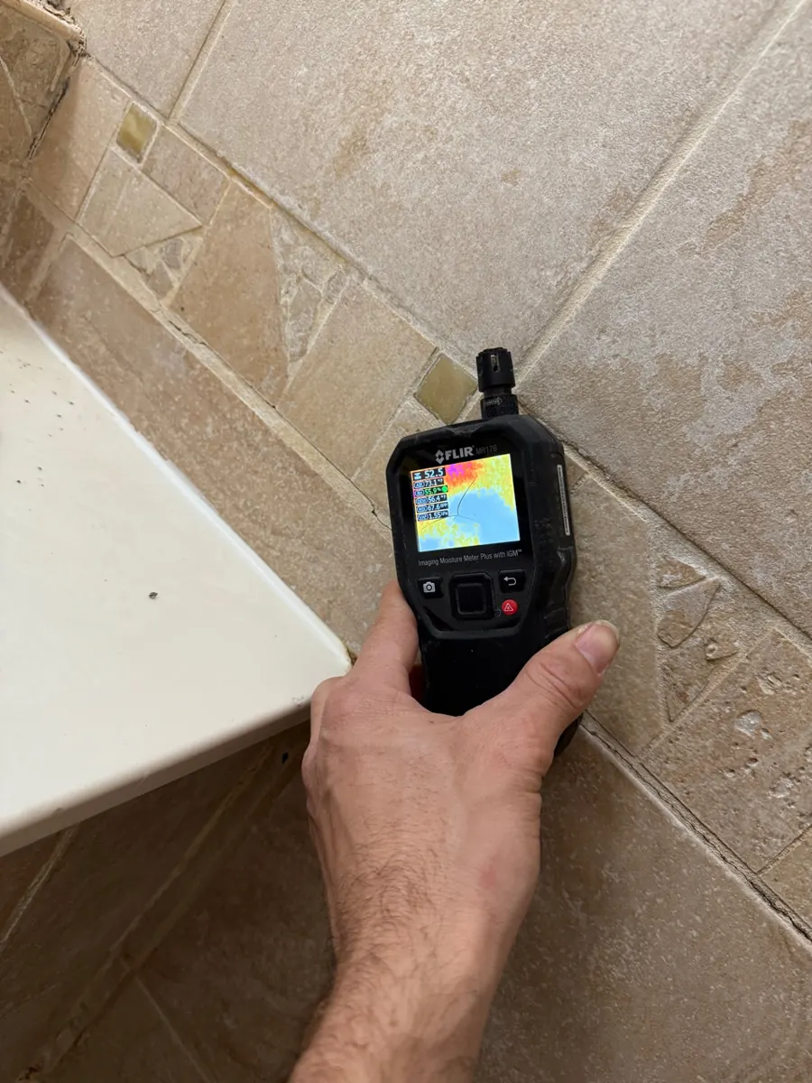Thermal moisture meter on shower wall tile beside a tub deck in a Northwest Las Vegas home