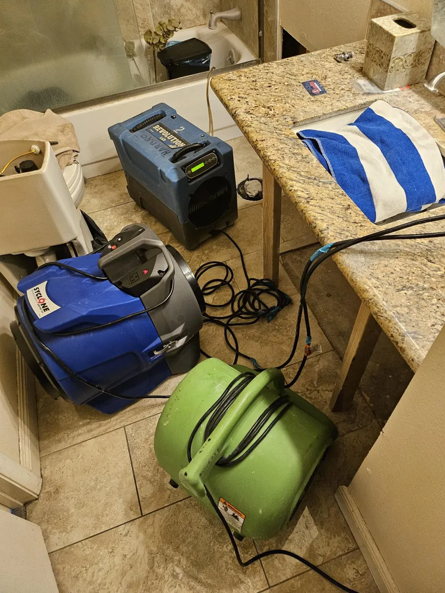 Dehumidifier, air scrubber and air mover in a Paradise bathroom beside the vanity