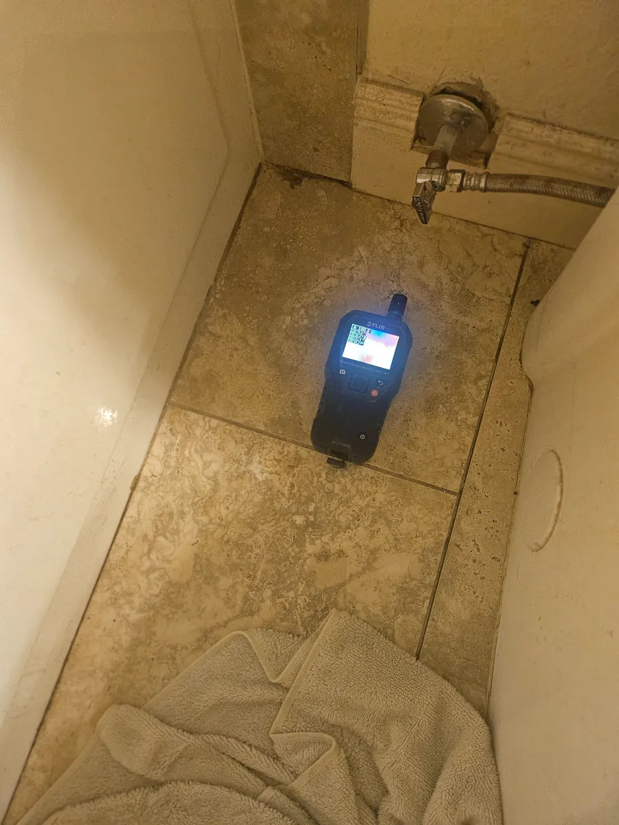 Imaging moisture meter on bathroom floor tile near a supply valve in a Paradise home