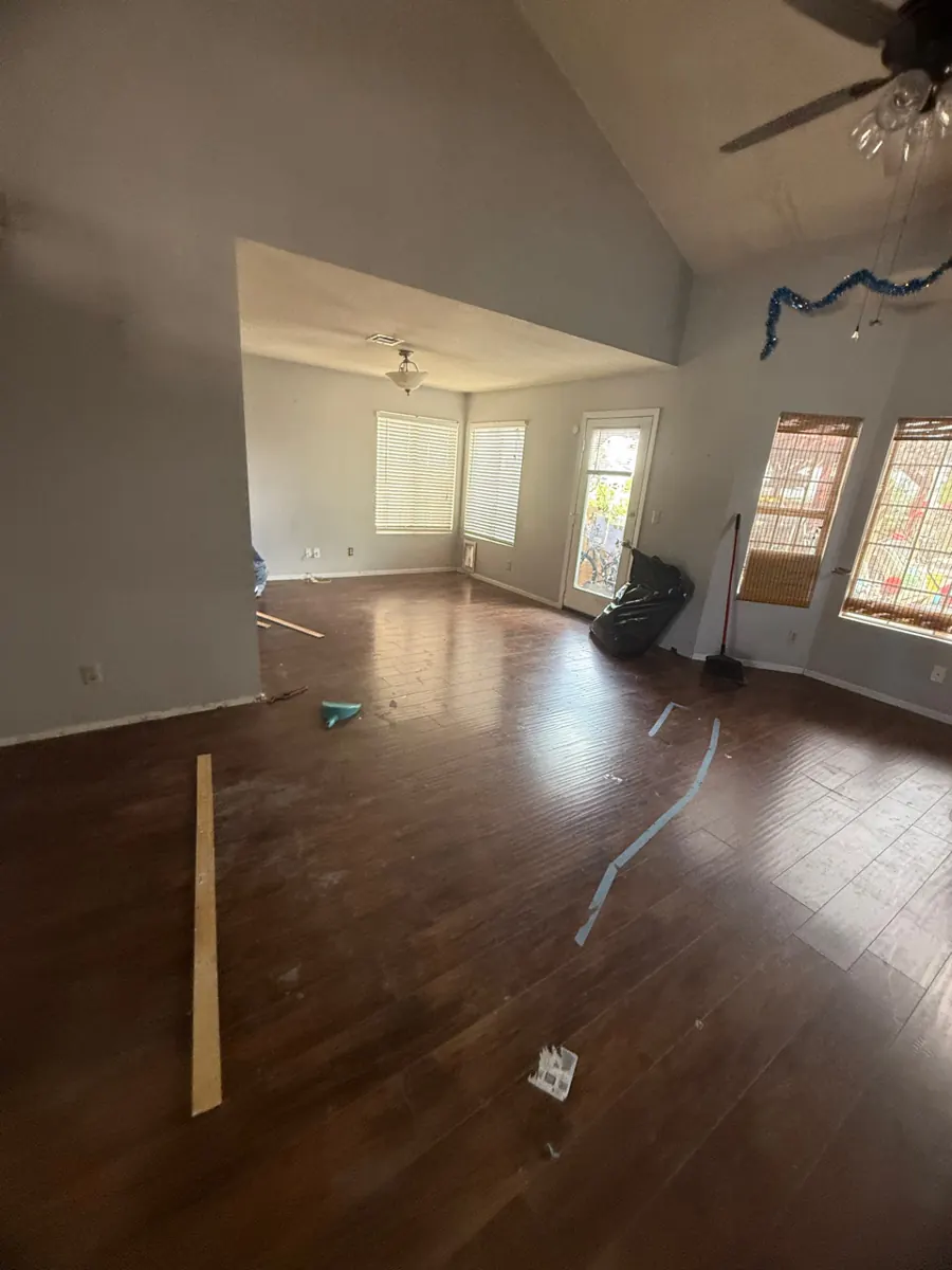 Empty living room with vaulted ceiling after contents pack-out in a Pittman home
