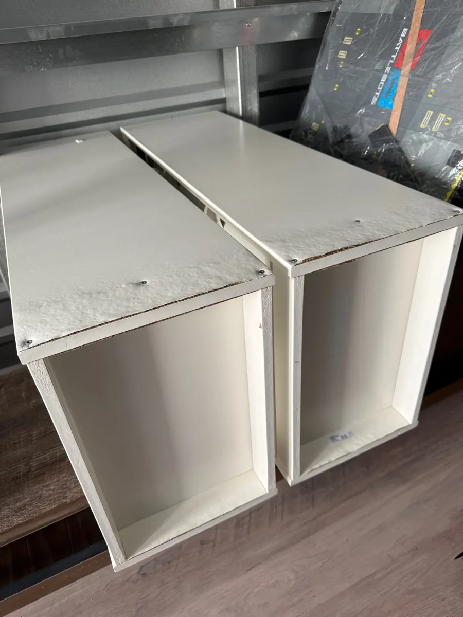 Two white drawer boxes with swollen tops photographed during a Red Rock Country Club pack-out