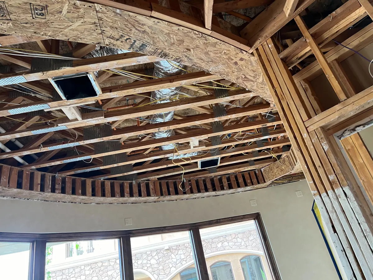 Rounded room with the ceiling opened to joists and ducts above the windows in a Red Rock Country Club home