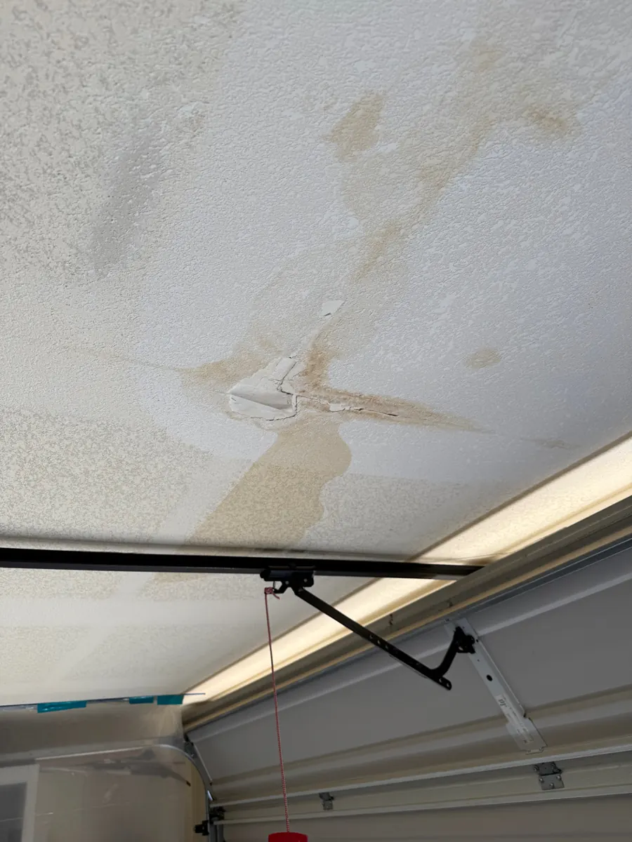 Water stain and peeling drywall tape on a garage ceiling in a River Mountain home