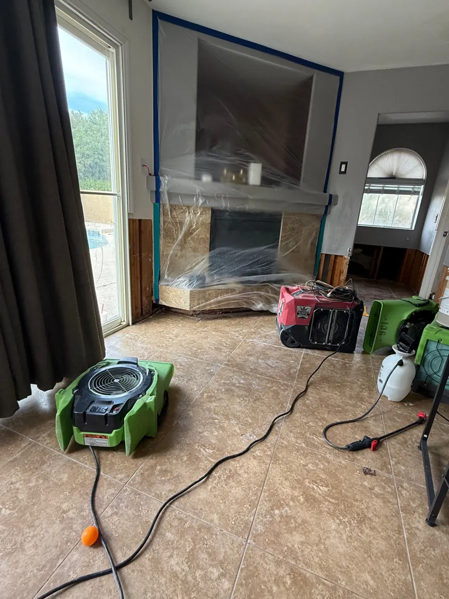 Air movers and a dehumidifier on the tile floor of a Silverado Ranch living room