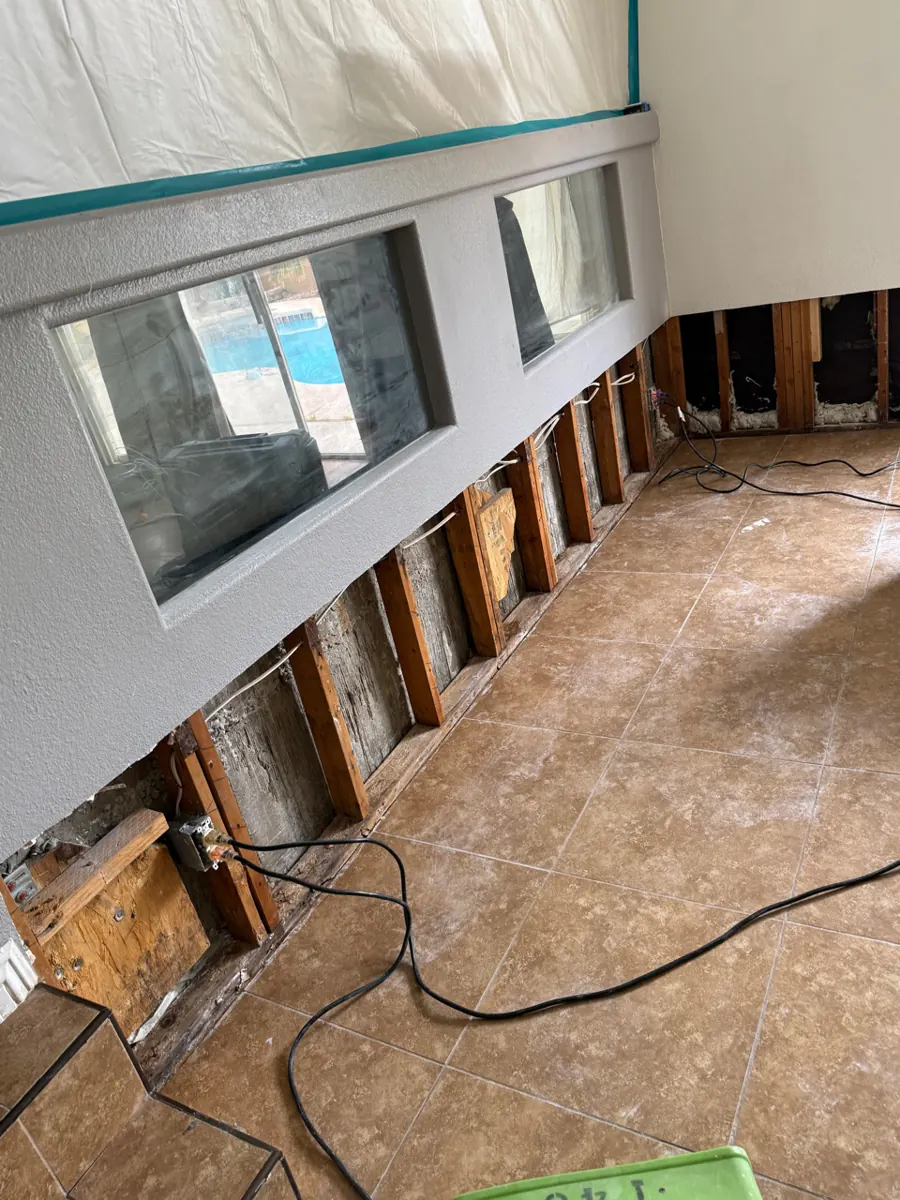Long run of lower wall opened to the studs above a tile floor in a Silverado Ranch home