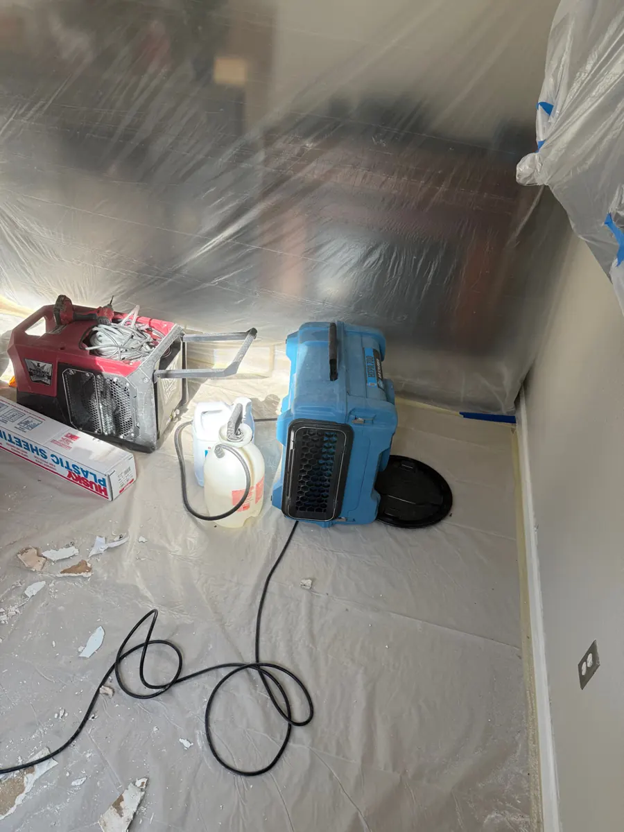 Air scrubber and dehumidifier running in a plastic-lined room in a Southern Highlands home