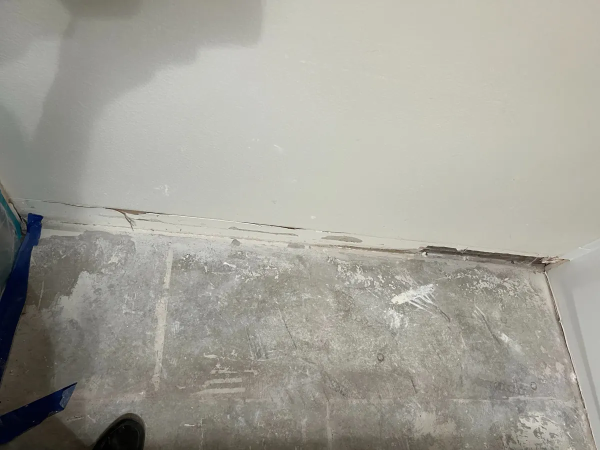 Bathroom floor tile and baseboard removed down to bare slab in a Spring Valley home