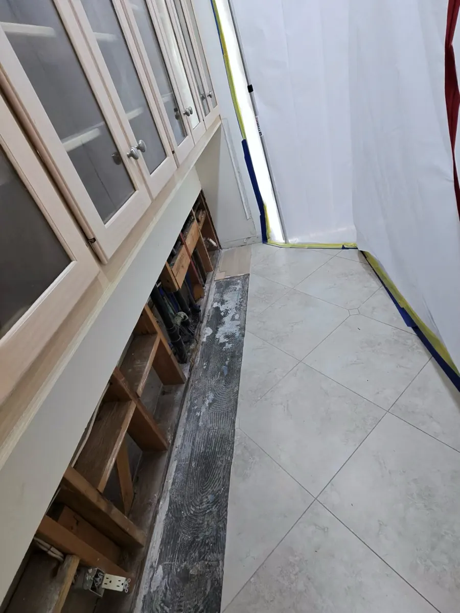 Row of glass-front cabinets with the lower boxes removed and flooring cut out in a Spring Valley home