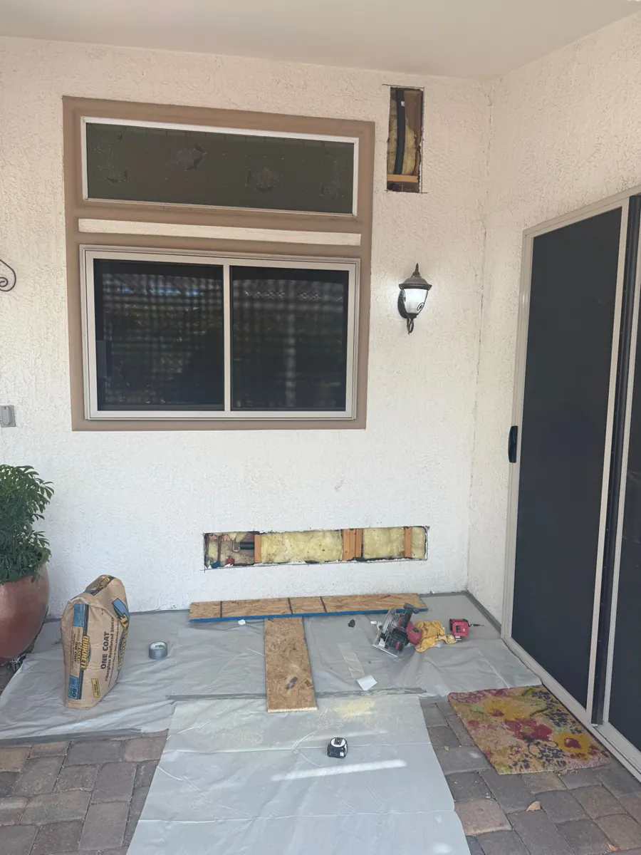 Patio wall with stucco openings showing insulation and framing in Sun City Summerlin