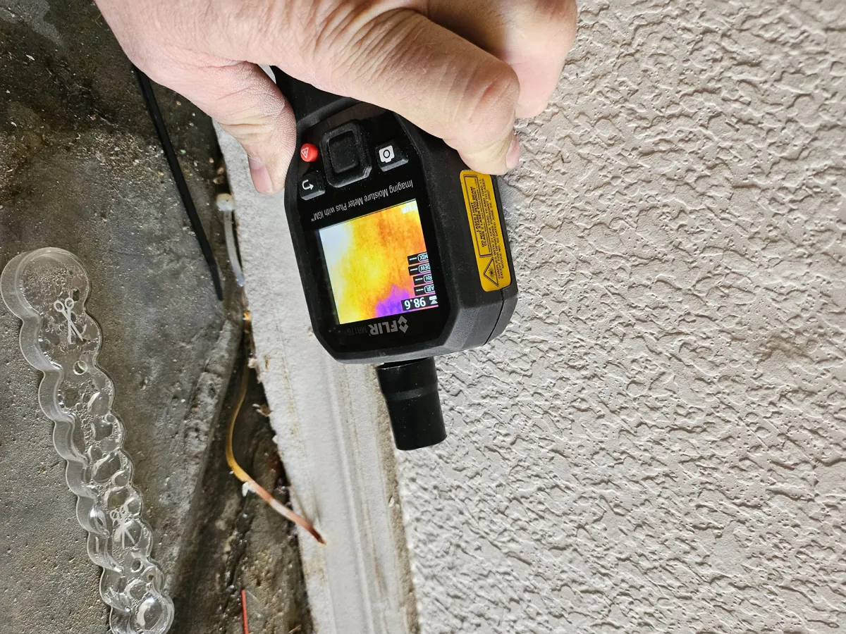 Thermal moisture meter at the base of a textured garage wall in Sun City Summerlin