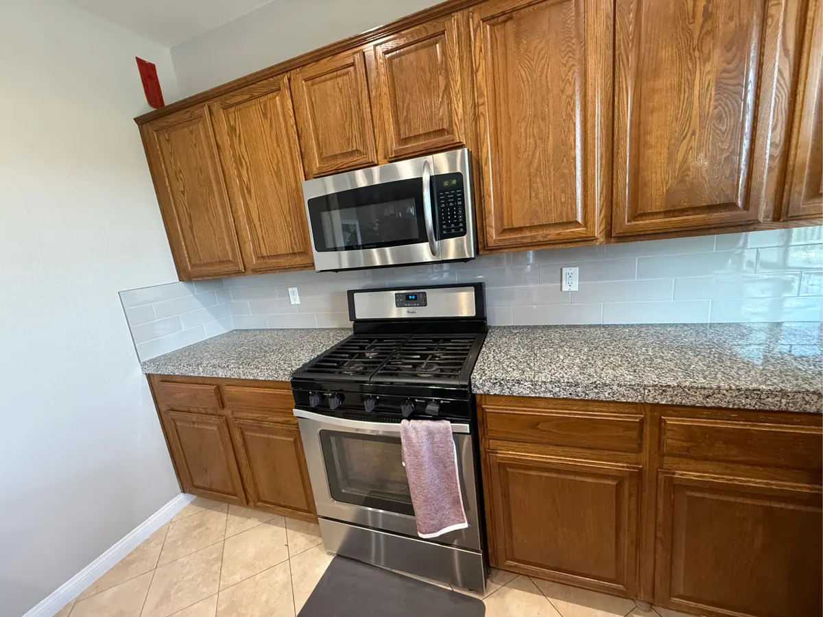 Gray subway tile backsplash behind the range and counters in a West Henderson kitchen