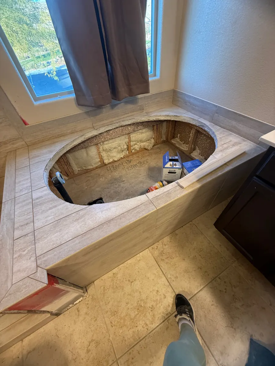 Tiled tub deck with an empty oval opening before tub install in West Henderson