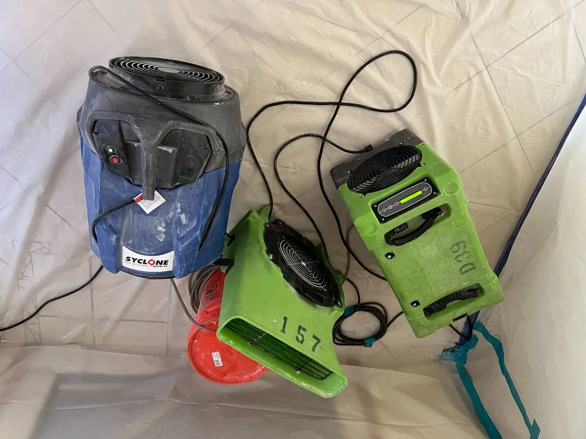 Air scrubber, air mover and dehumidifier on plastic sheeting in a West Sahara home