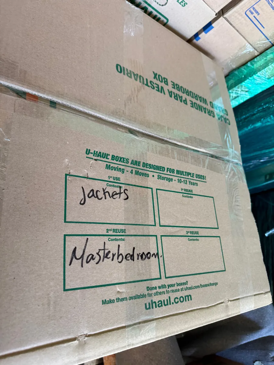 Packed moving box labeled by room during a Whitney contents pack-out