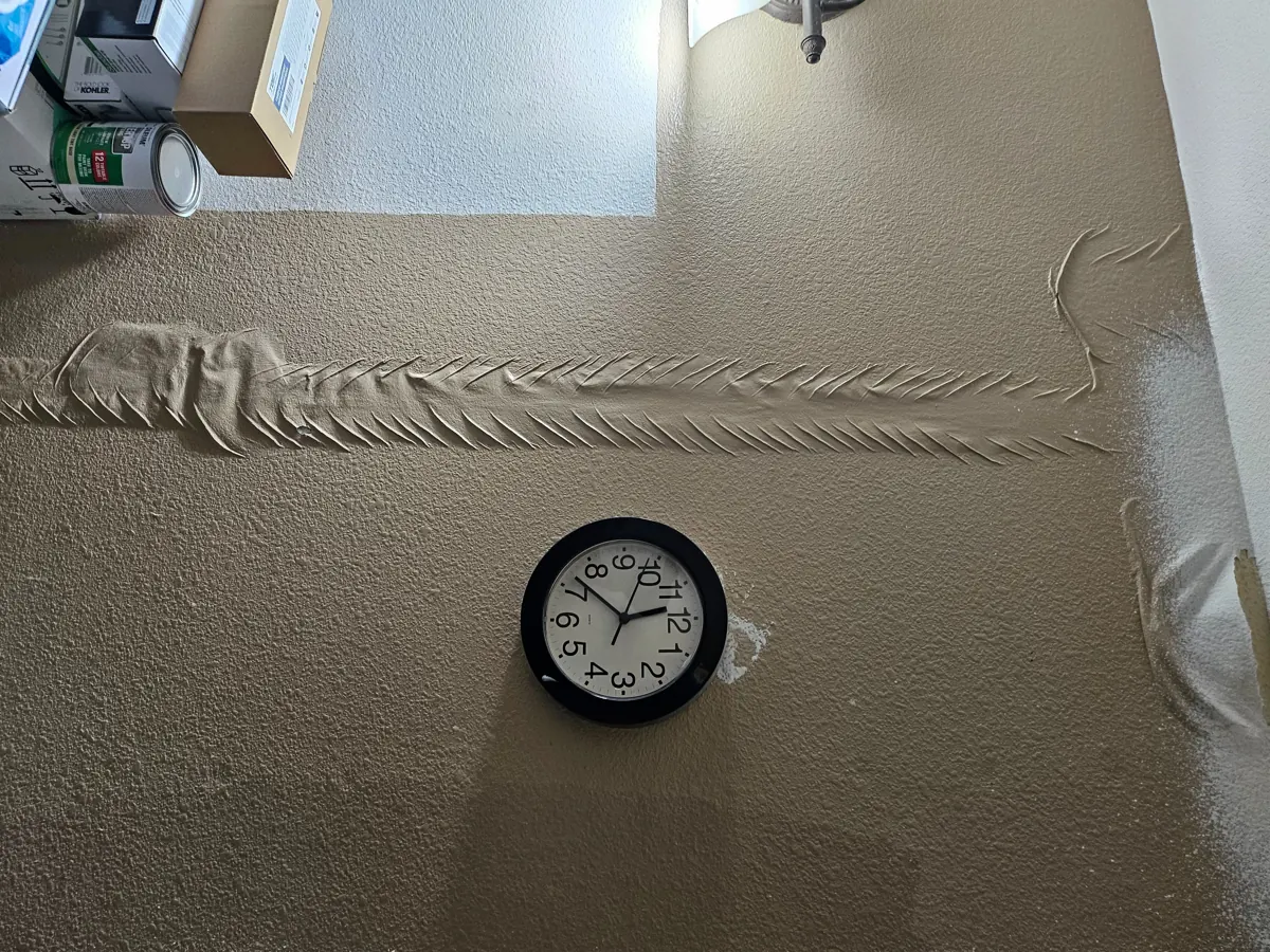 Bubbled, lifting drywall tape across a wall in a Whitney home