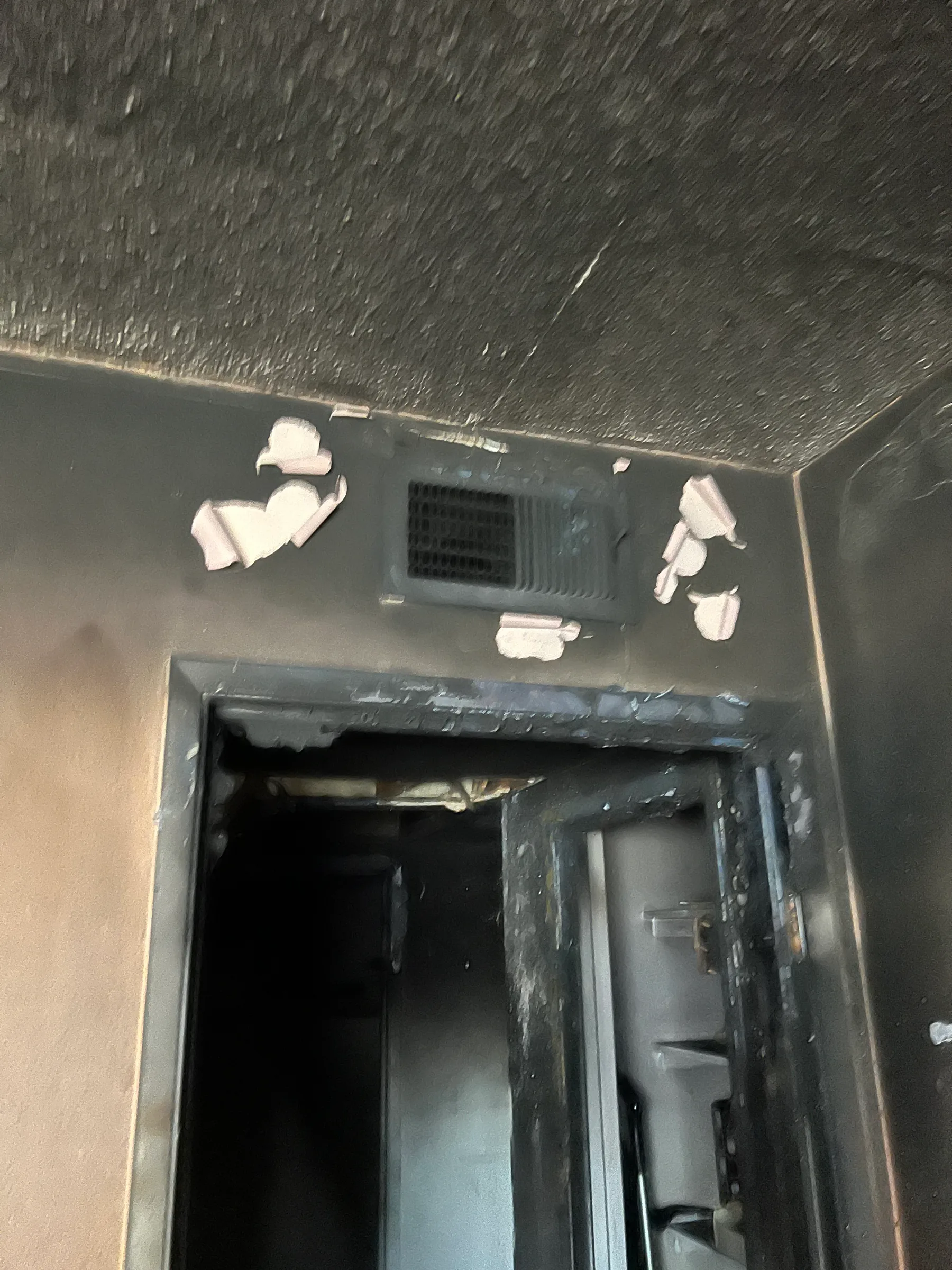 Charred doorway with soot damage around the ceiling and wall opening