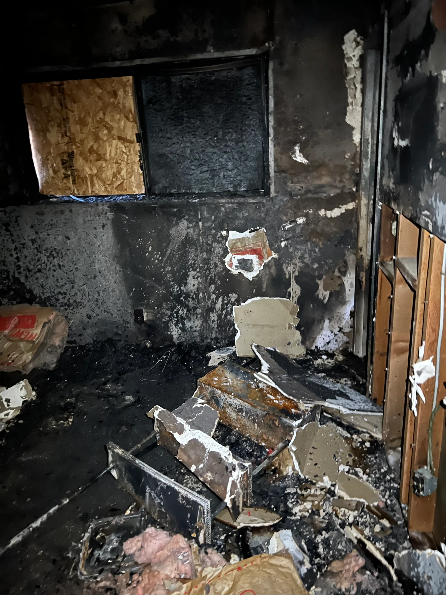 Severe fire damage with charred walls and debris inside a Henderson property