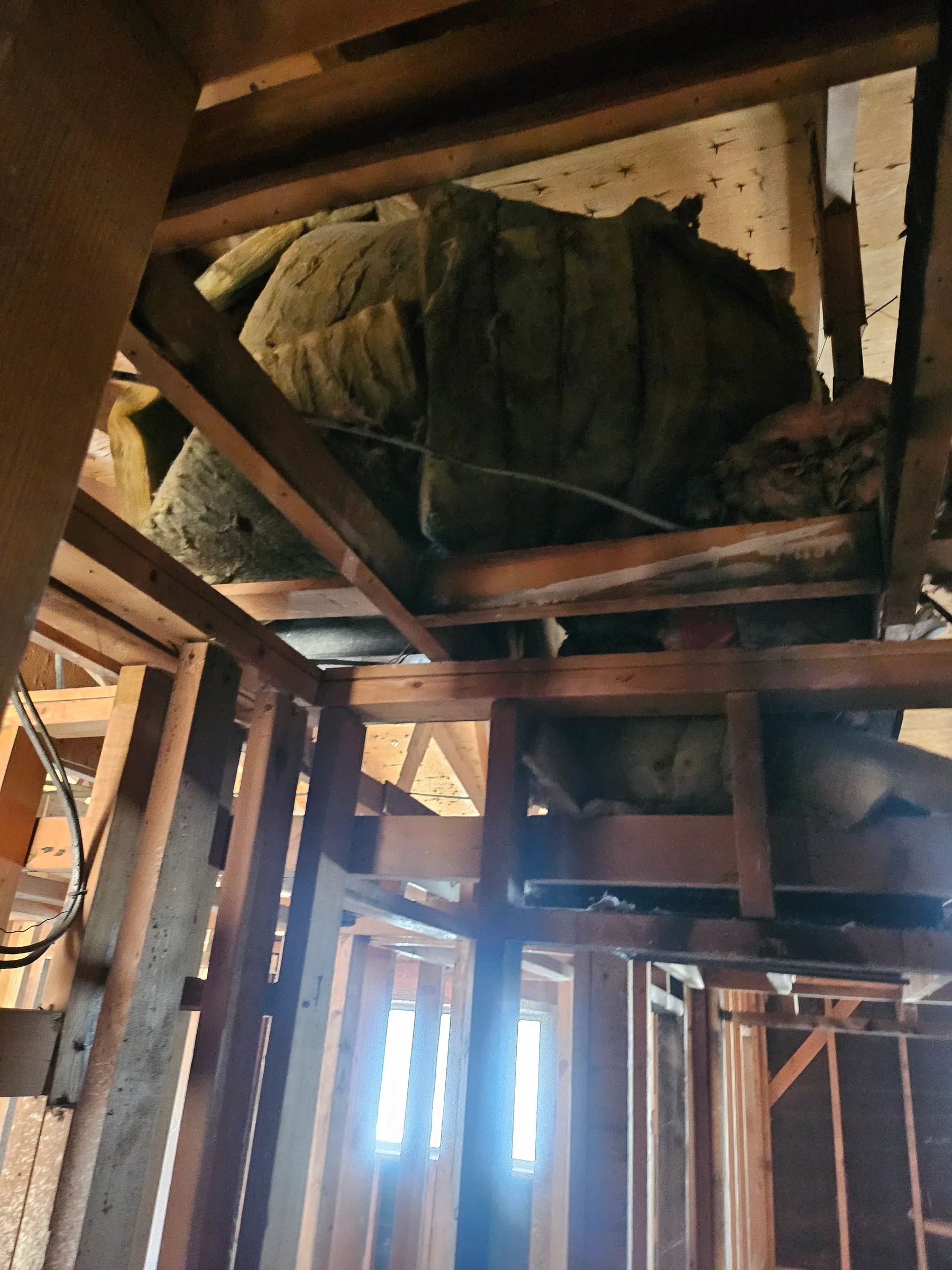 Post-fire cleanup exposing framing and ceiling structure after demolition