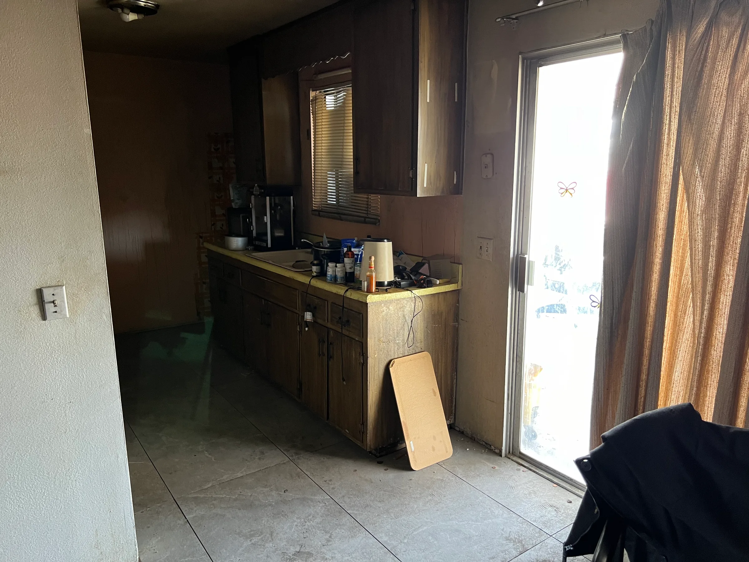 Kitchen and living area with visible smoke staining after a fire