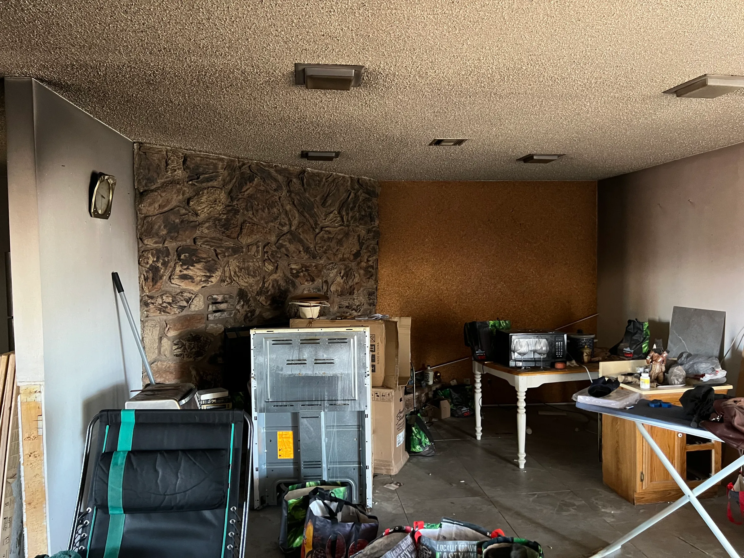 Smoke-stained living room after a fire with soot visible on walls and ceiling