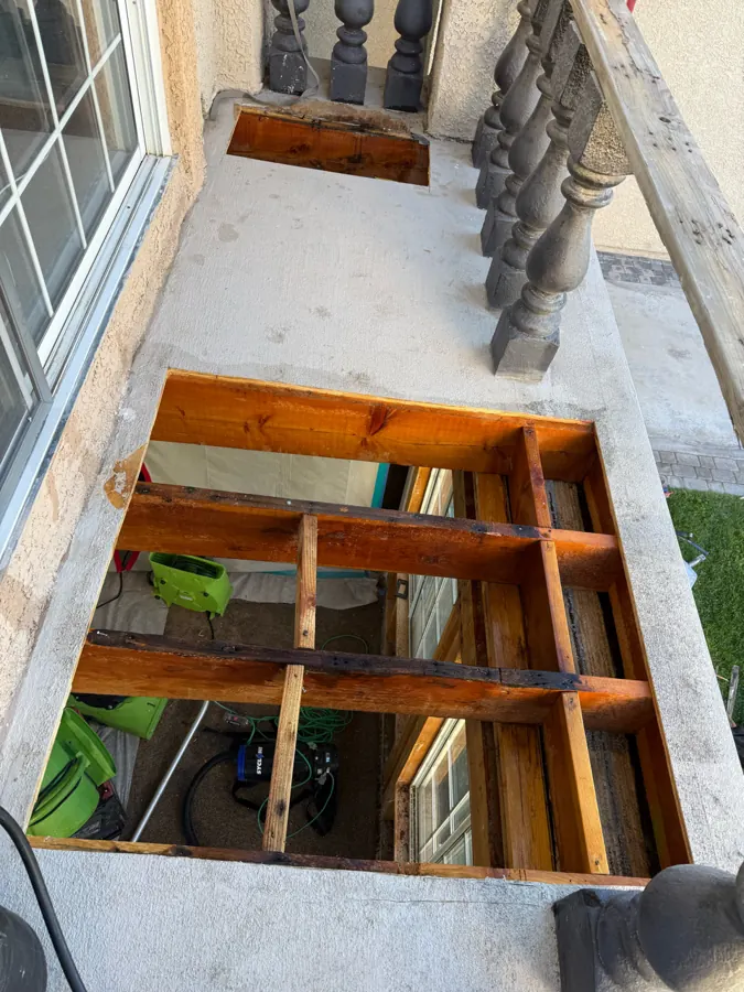 Balcony deck opened down to the joists to expose water-damaged framing on a two-story home in The Lakes, Las Vegas