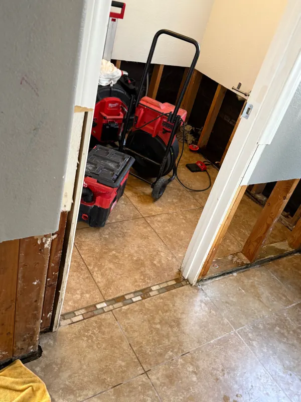 Air movers drying water-damaged flooring from an appliance leak in Henderson