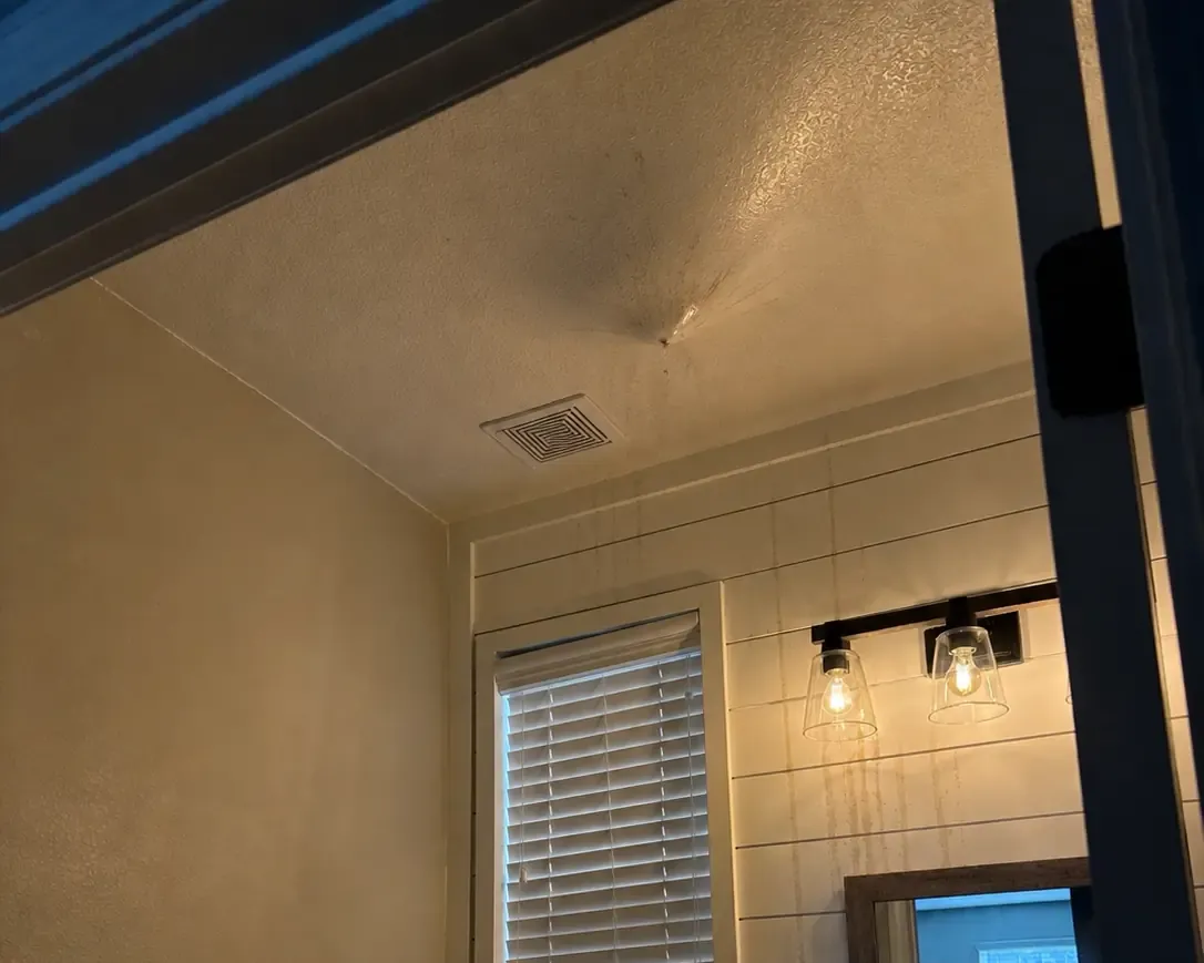 Water damaged ceiling and wall from an upstairs pipe break
