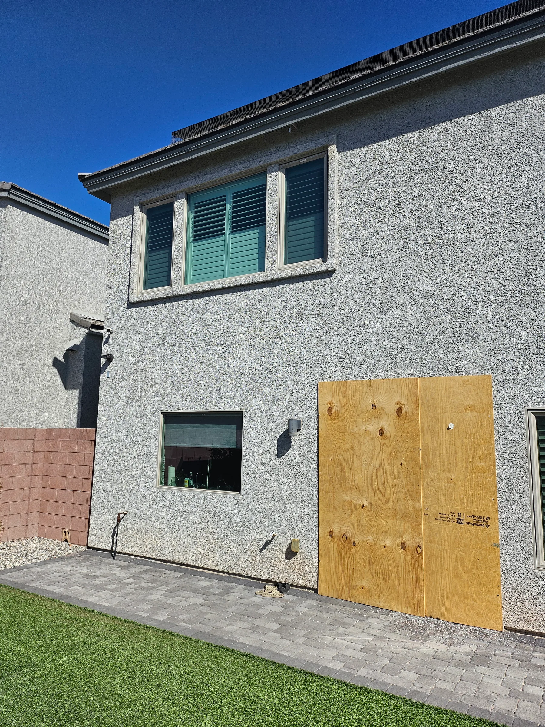 Exterior board-up after broken glass and vandalism damage