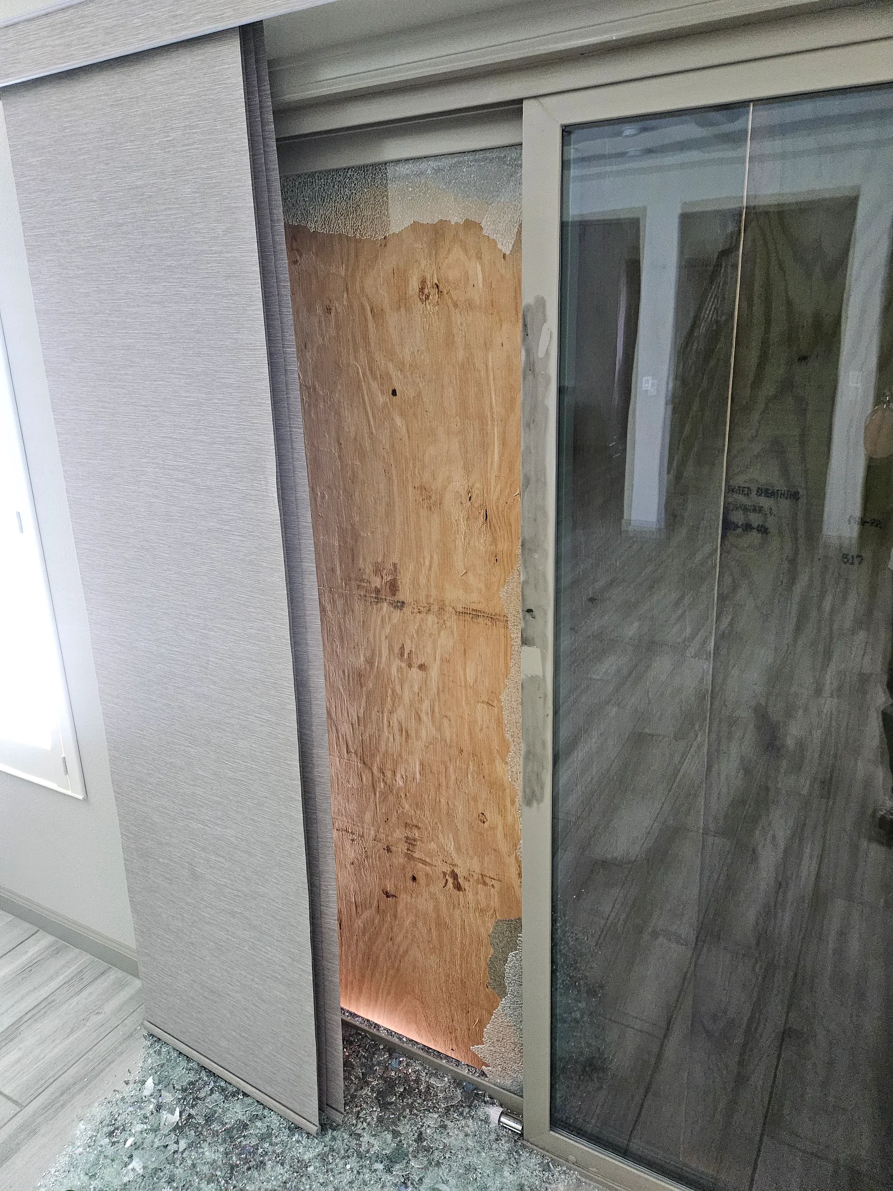 Vandalism-damaged sliding door secured before reconstruction in Henderson